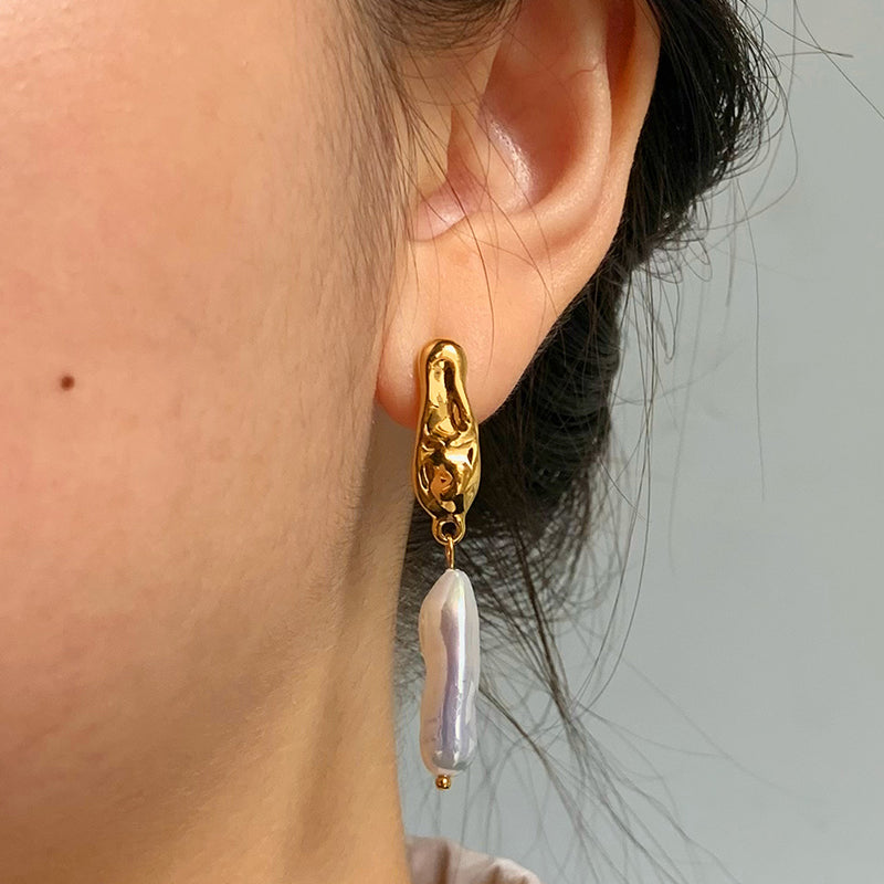 Gold molten textured stud earrings with hanging baroque pearl drop